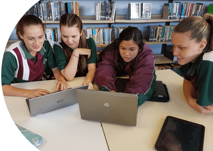 Students on their laptops doing work