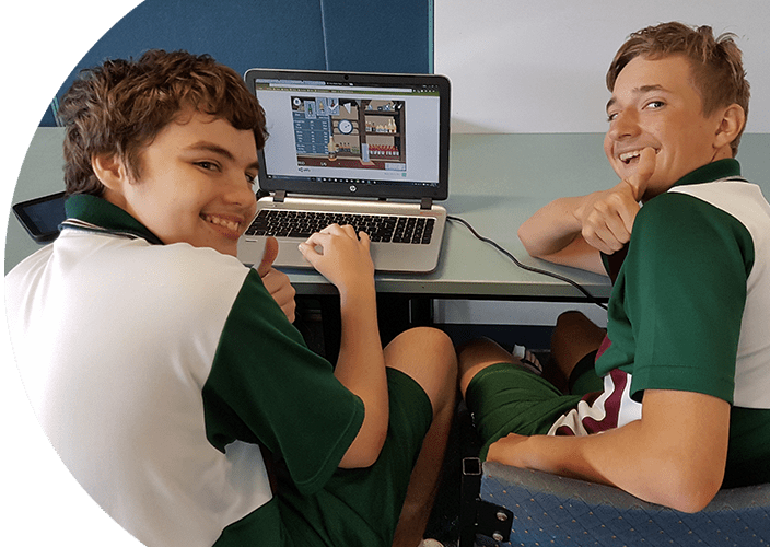 A couple students playing a game on their laptop