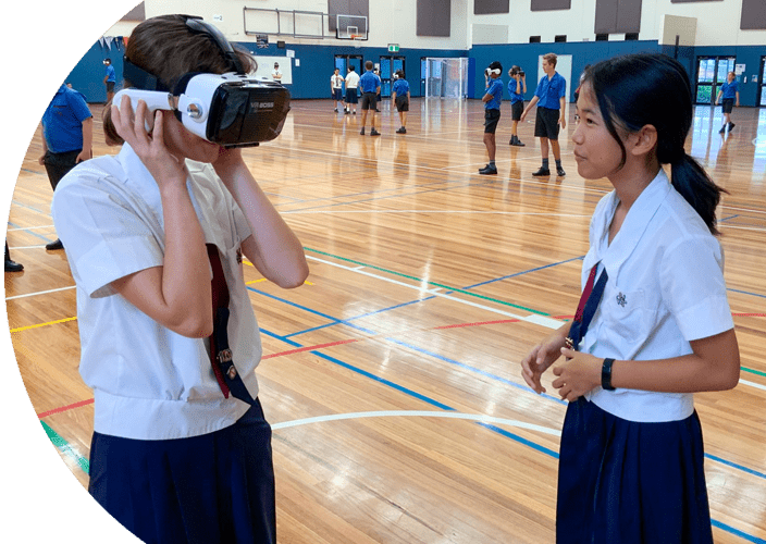 A couple students experiencing virtual reality at school