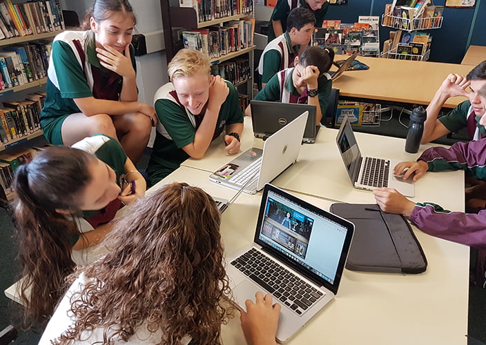 A number of school students playing some games on their laptop