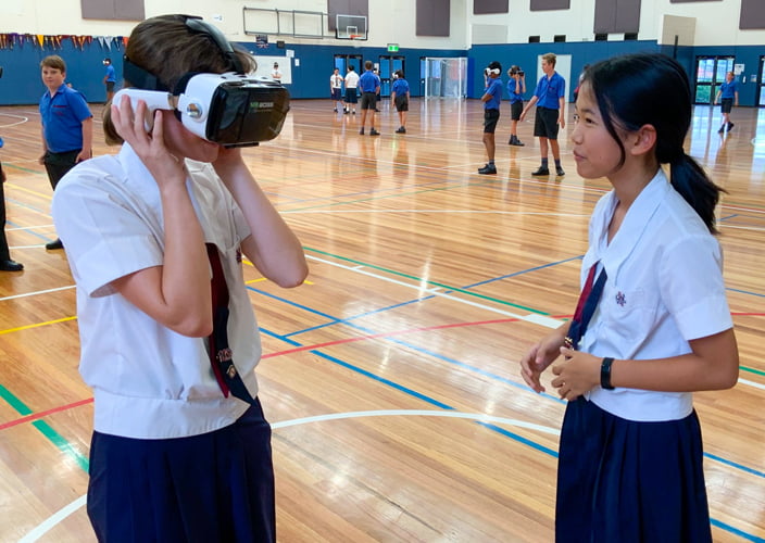 A couple students experiencing virtual reality at school